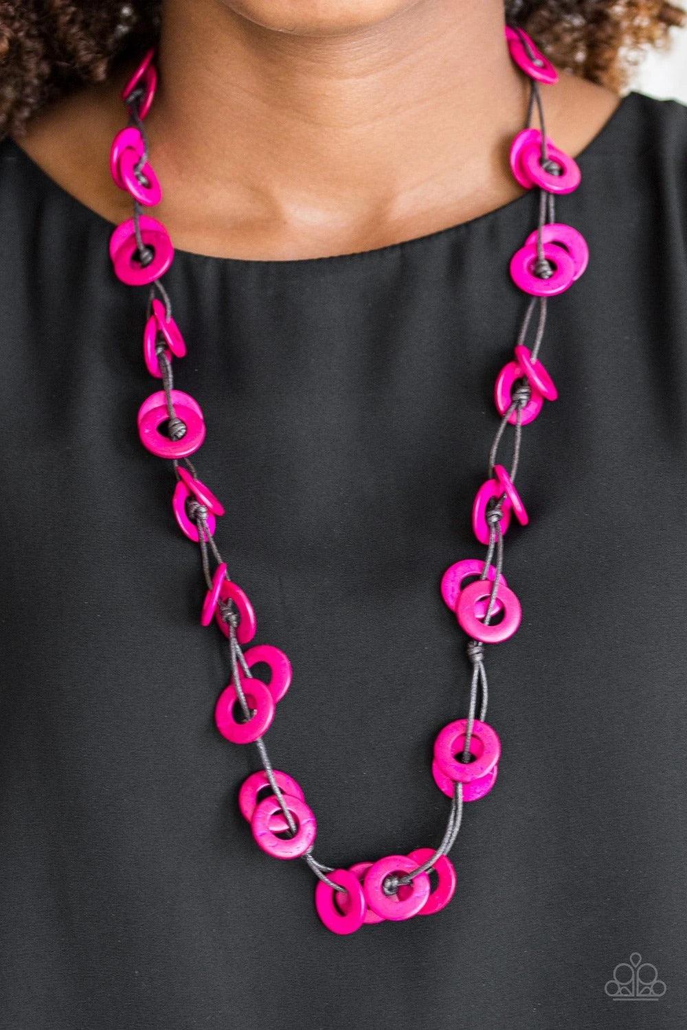 Paparazzi Accessories Waikiki Winds - Pink Shiny brown cording knots around vivacious pink wooden discs, creating a colorful display across the chest. Features a button loop closure. Sold as one individual necklace. Includes one pair of matching earrings.