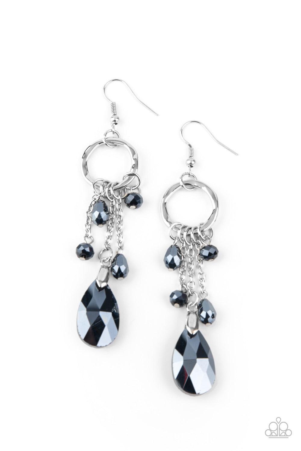 Paparazzi Accessories Glammed Up Goddess - Blue Attached to sections of shimmery silver chains, a mismatched collection of metallic blue crystal-like beads swing from the bottom of a hammered silver hoop for an elegantly exaggerated look. Earring attaches