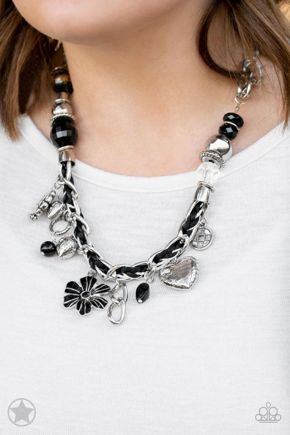 Paparazzi Accessories Charmed I Am Sure - Black Black and ivory cording is braided through a chunky silver chain. A unique variety of charms decorate the piece including a delicate flower and a heart. Heart is inscribed with the phrase "With All My Heart"