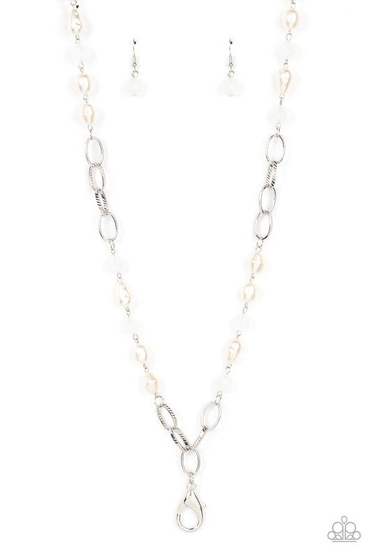 Paparazzi Accessories Tea Part Tango - White *Lanyard Featuring imperfect shapes, luscious pearly beads join opaque white faceted beads along sections of chunky silver chain across the chest for a glamorous look. Features an adjustable clasp closure. Sold
