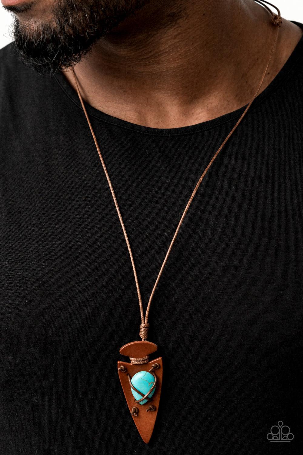 Paparazzi Accessories Hold Your ARROWHEAD Up High - Blue Shiny brown cording crisscrosses across the front of an earthy turquoise stone, knotting the colorful accent in place across the front of a brown leather arrowhead pendant for an earthy look. Featur