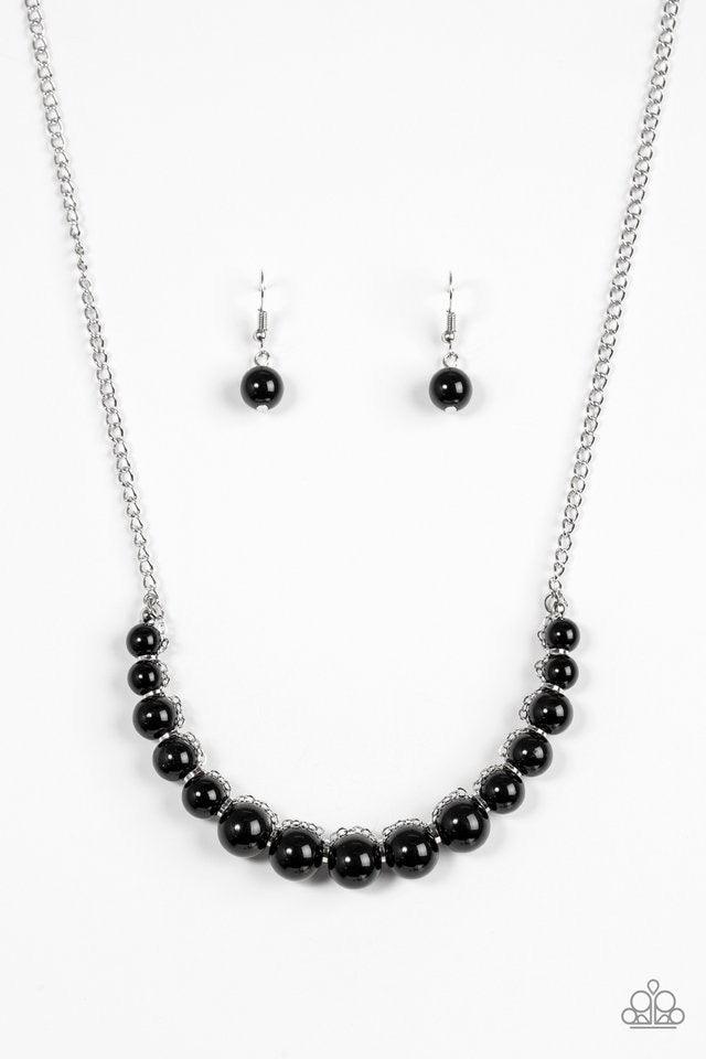 Paparazzi Accessories The FASHION Show Must Go On! - Black A classic strand of shiny black beads is threaded along an invisible string, creating a stationary pendant below the collar. Infused with shimmery silver accents, silver chain weaves atop the bead