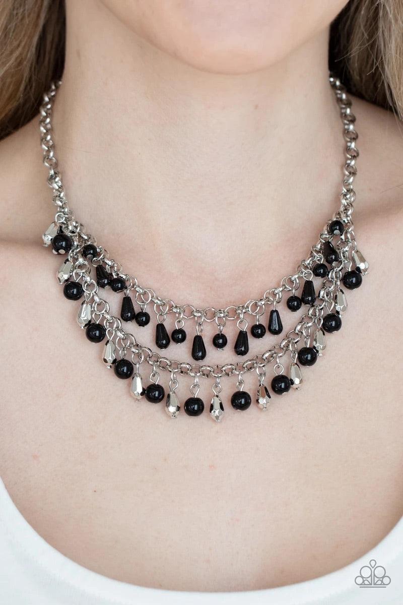 Paparazzi Accessories Big Money - Black A glamorous collection of bubbly black beads, faceted silver beads, and shiny black teardrop beads alternate along two strands of chunky silver chains, creating a flirtatious fringe below the collar. Features an adj