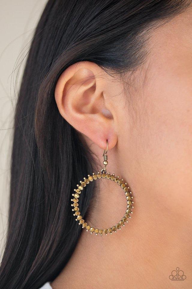 Paparazzi Accessories Spark Their Attention - Brass Glittery aurum rhinestones are encrusted along a studded brass hoop for an edgy-glamorous look. Earring attaches to a standard fishhook fitting. Jewelry