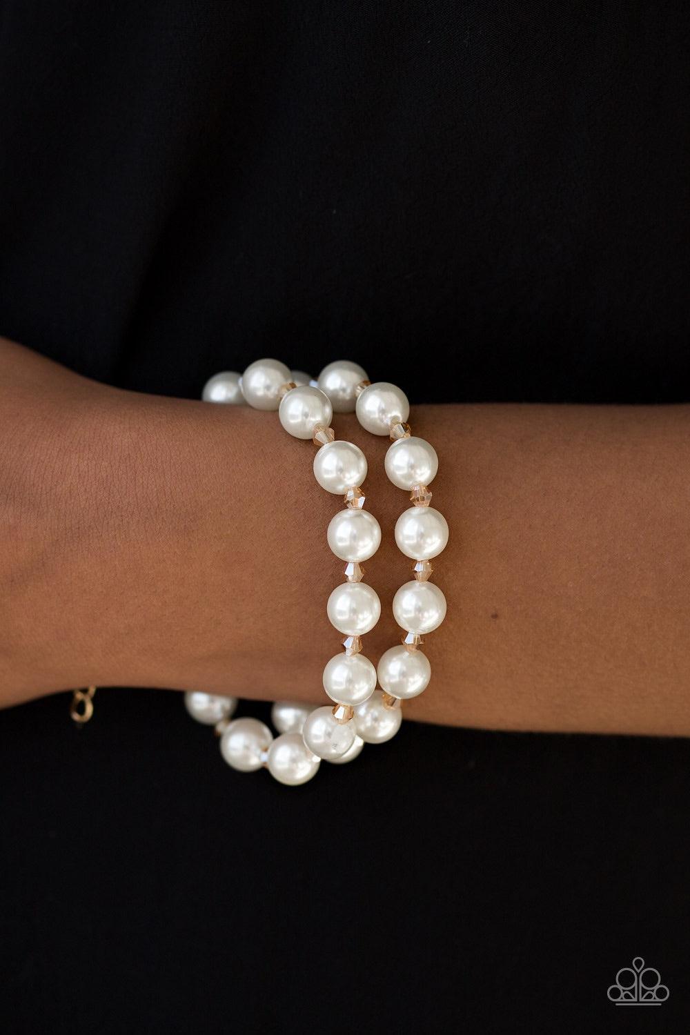 Paparazzi Accessories BALLROOM And Board - Gold Rows of dainty gold crystal-like beads and classic white pearls are strung across the wrist for a timeless look. Features an adjustable clasp closure. Jewelry