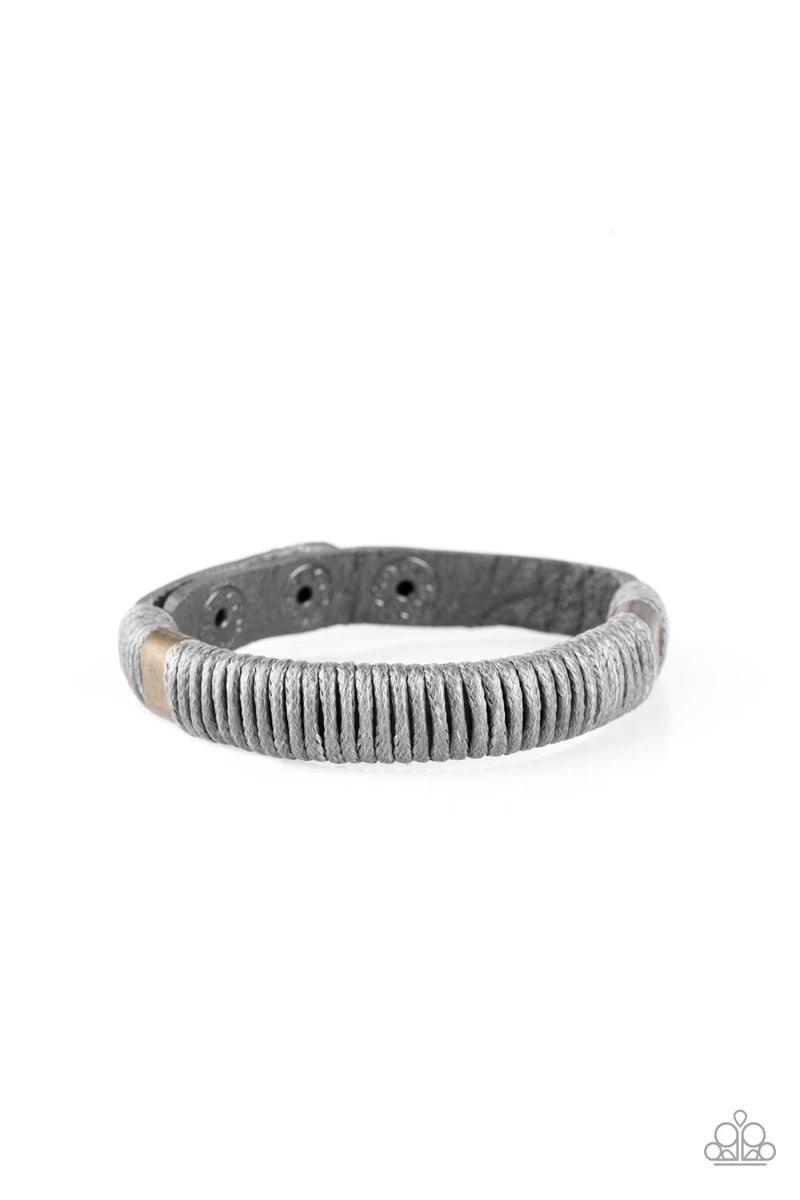 Paparazzi Accessories What Happens On The Road ~Silver Infused with metallic accents, shiny gray cording wraps around a gray leather band for an urban look. Features an adjustable snap closure. Sold as one individual bracelet.