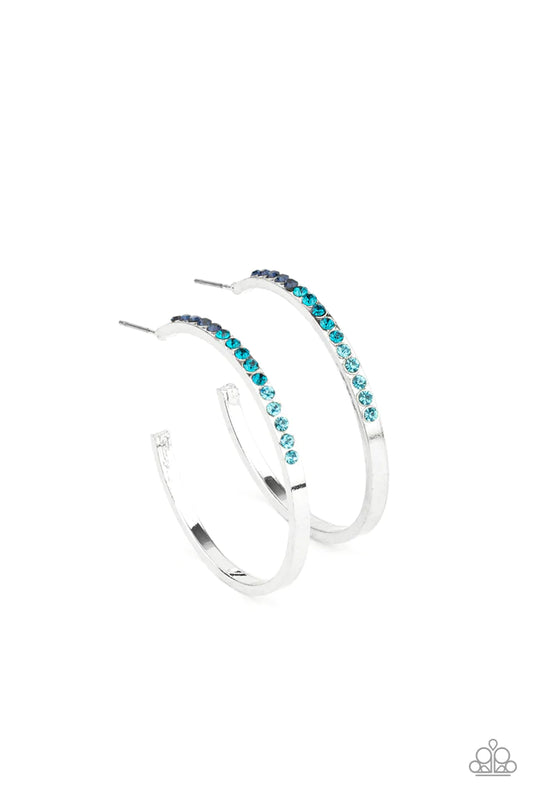 Paparazzi Accessories Somewhere Over the OMBRE - Blue The front half of a dainty silver hoop is encrusted in an ombre of blue rhinestones, creating a sparkly spectrum of color. Earring attaches to a standard post fitting. Hoop measures approximately 1 1/2