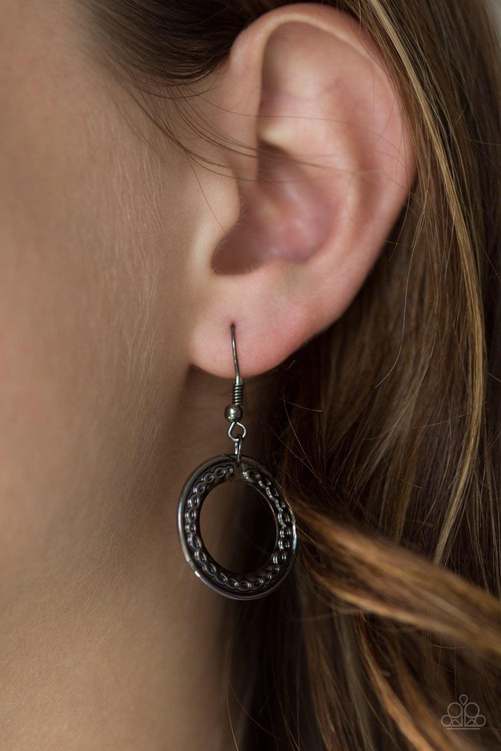 Paparazzi Accessories Savagely She-Wolf - Multi Embossed in swirling tribal detail, brass, copper, and gunmetal frames swing from the bottom of an elongated gunmetal chain, creating an airy stacked pendant. Features an adjustable clasp closure. Jewelry