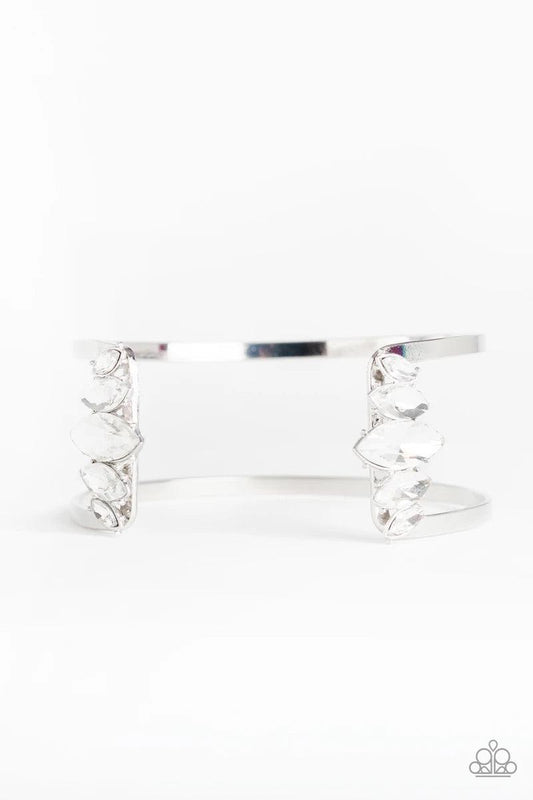 Paparazzi Accessories Glam Power - White Featuring regal marquise style cuts, an array of white rhinestones decorate the edges of an airy silver cuff for an edgy, glamorous finish. Sold as one individual bracelet. Jewelry