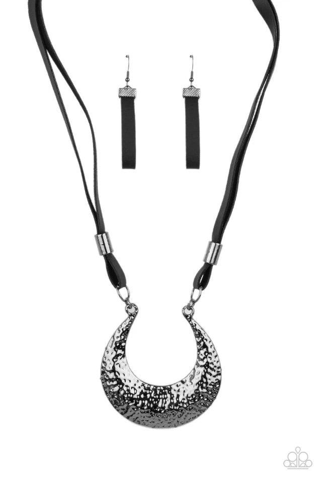 Paparazzi Accessories Majorly Moonstruck - Black Infused with glistening gunmetal beads, strips of black leather link to an oversized half moon pendant that is hammered in a blinding gunmetal finish, creating an edgy statement piece below the collar. Feat