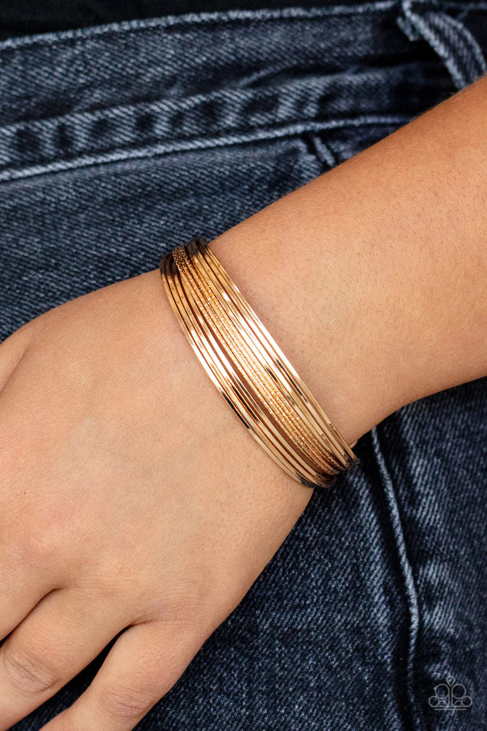 Paparazzi Accessories This Girl is on WIRE - Gold Capped in gold fittings, rows of smooth gold wires flank a section of diamond cut gold wire around the wrist, creating an edgy cuff. Sold as one individual bracelet. Jewelry