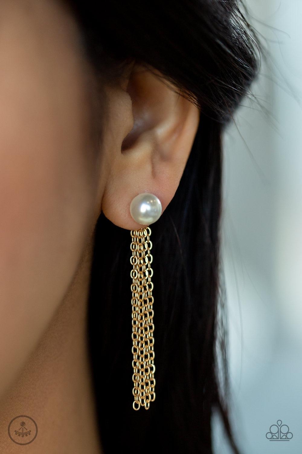 Paparazzi Accessories Rebel Refinement - Gold A solitaire white pearl attaches to a double-sided post, designed to fasten behind the ear. Brushed in a high-sheen shimmer, glistening gold chains peek out beneath the ear for a bold tasseled look. Earring at