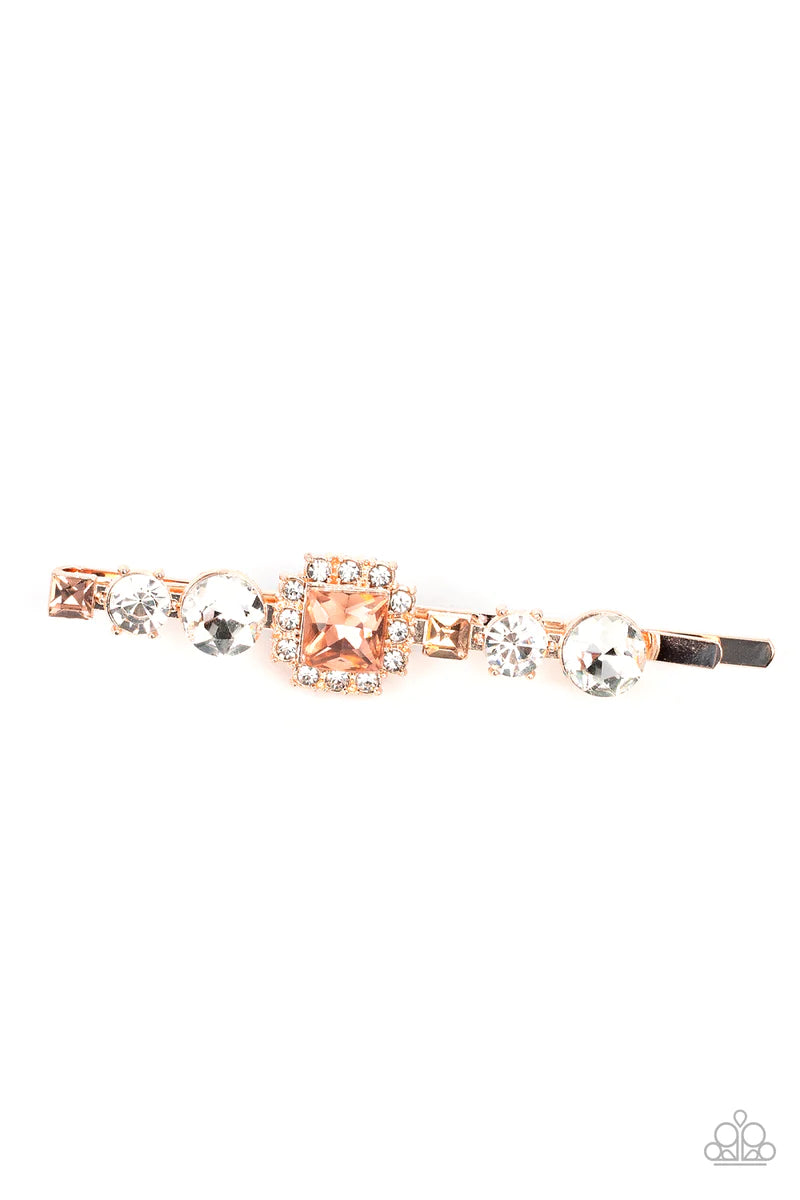 Paparazzi Accessories Couture Crasher - Gold Featuring a brilliant radiant cut peach gem surrounded by a frame of dainty white rhinestones, a mismatched collection of white round and square peach rhinestones coalesce into a stunning display. Sold as one i