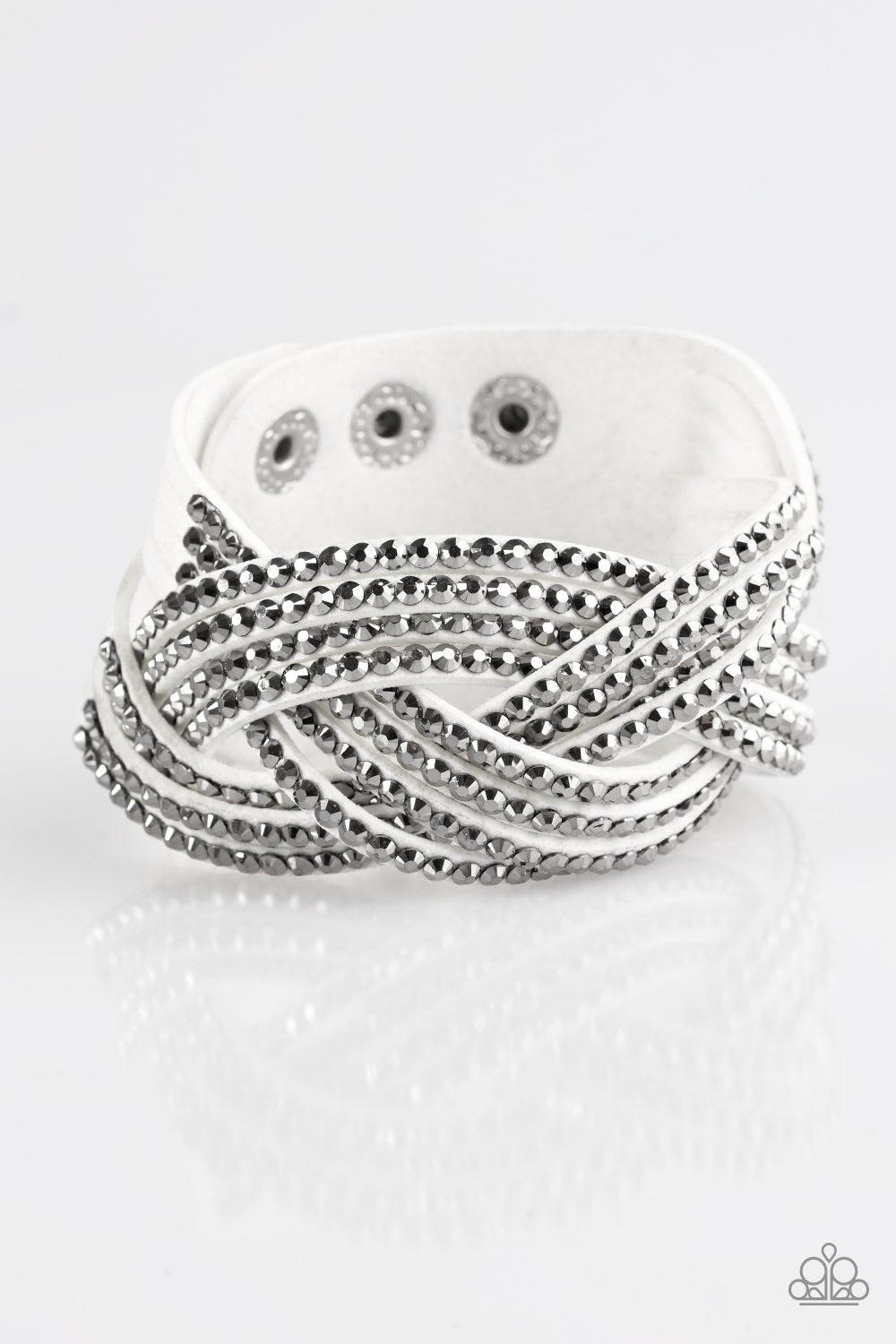 Paparazzi Accessories Top Class Chic - White Oversized hematite rhinestones are encrusted along strands of crisscrossing white suede, creating a fierce shimmer around the wrist. Features an adjustable snap closure. Jewelry
