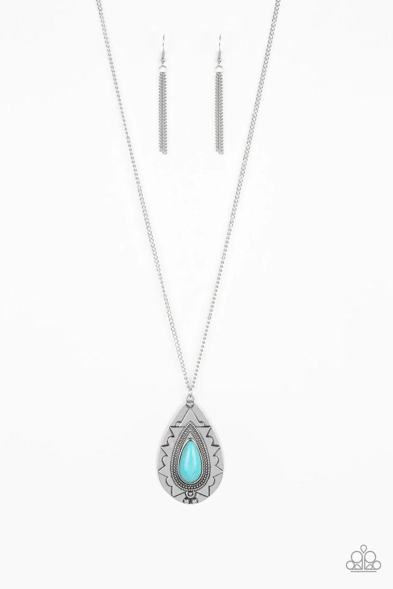 Paparazzi Accessories Sedona Solstice - Blue Chiseled into a tranquil teardrop, a refreshing turquoise stone is pressed into an ornate silver frame. The whimsical pendant swings from the bottom of a lengthened silver chain for a seasonal look. Features an