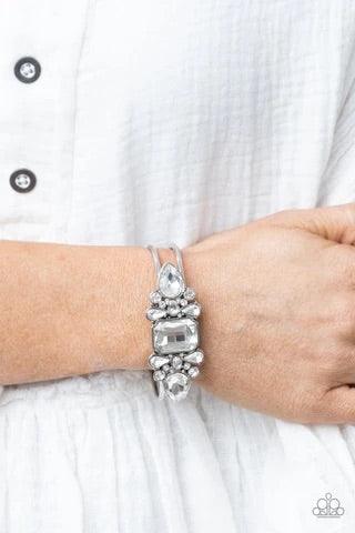 Paparazzi Accessories Call Me Old-Fashioned - White A blinding collection of round and marquise-cut white rhinestones are encrusted across the front of a shiny silver bar, curling around the wrist to create a timeless cuff-like bangle. Features a hinged c