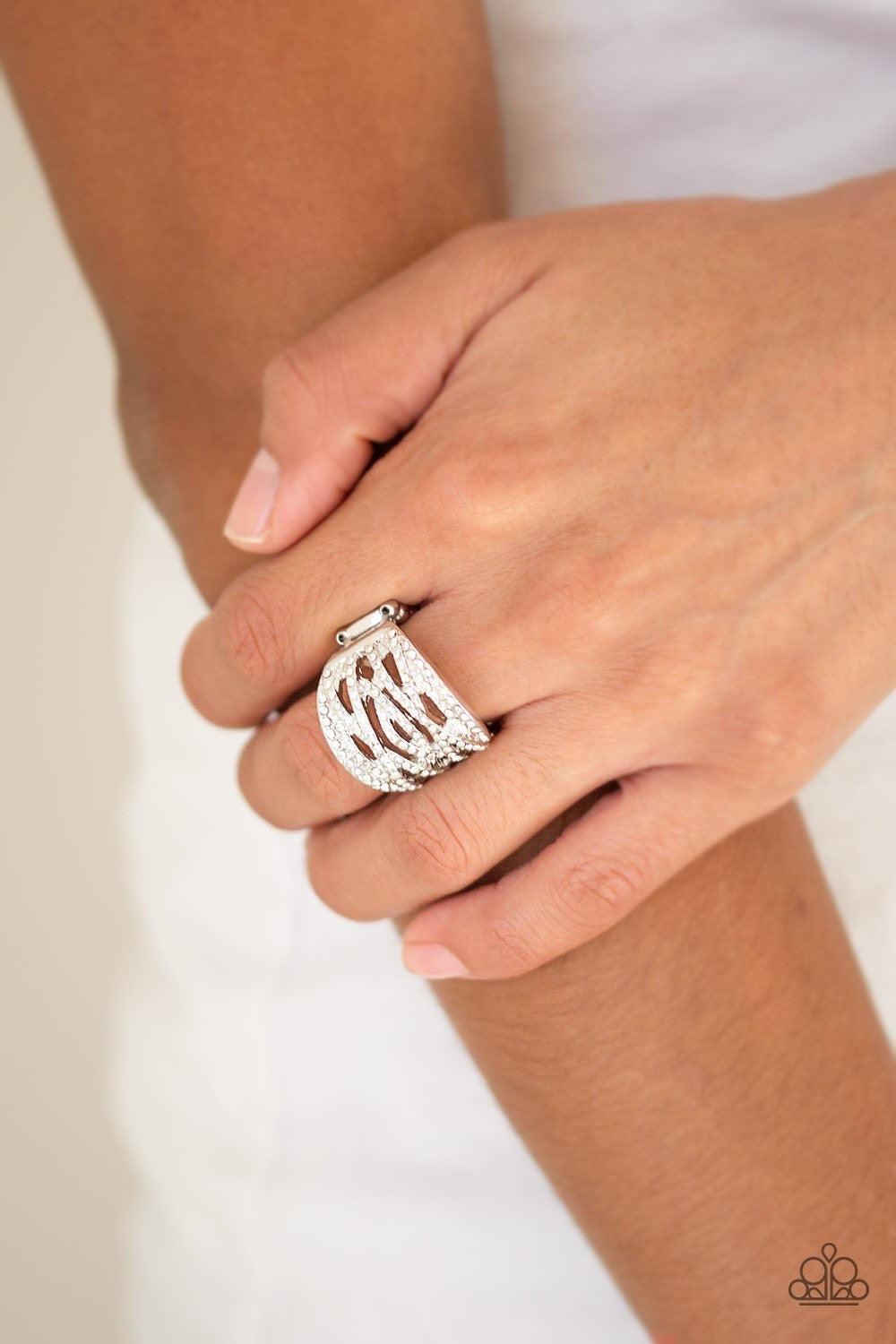 Paparazzi Accessories The Money Maker - White Radiating with dainty white rhinestones, glittery silver bands crisscross across the finger for a refined look. Features a stretchy band for a flexible fit. Jewelry