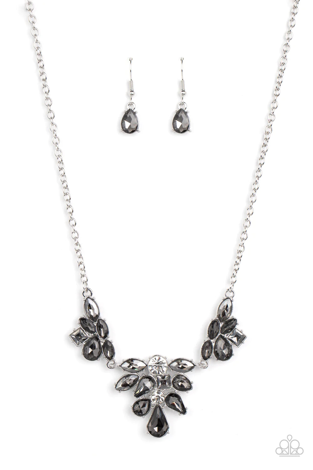 Paparazzi Accessories Completely Captivated - Silver Varying in cut and shimmer, bubbly clusters of mismatched white and smoky rhinestones coalesce into three sparkly frames for a captivating statement below the collar. Features an adjustable clasp closur