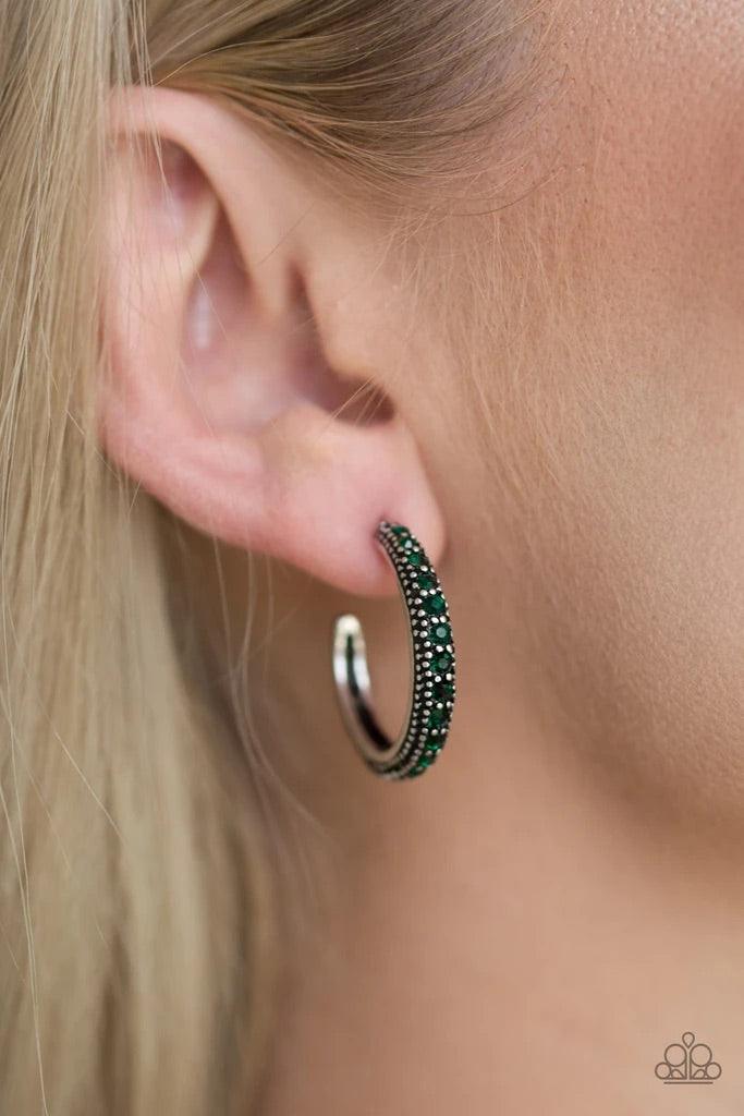 Paparazzi Accessories Twinkling Tinseltown - Green ENCRUSTED IN DAZZLING EMERALD RHINESTONES, A STUDDED SILVER HOOP SWINGS FROM THE EAR FOR A GLAMOROUS LOOK. EARRING ATTACHES TO A STANDARD POST FITTING. HOOP MEASURES 1" IN DIAMETER. SOLD AS ONE PAIR OF HO