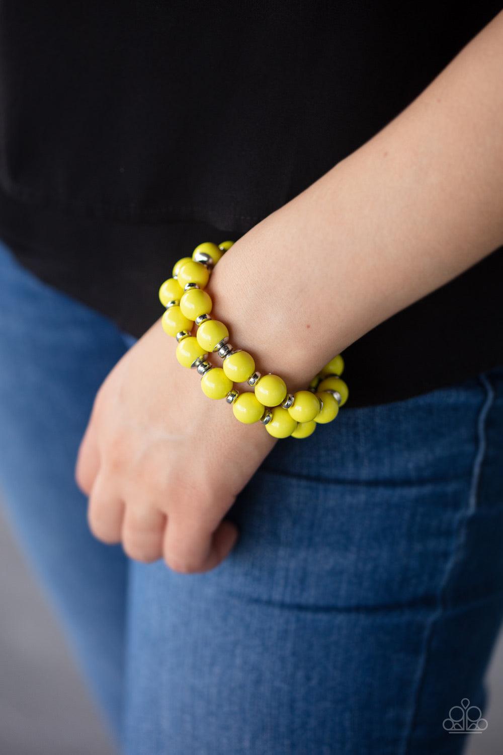 Paparazzi Accessories Bubble Blast Off - Yellow Connected together by two dainty silver fittings, a bubbly collection of yellow beads and shiny silver accents are threaded along two stretchy bands around the wrist for a bold pop of color. Jewelry