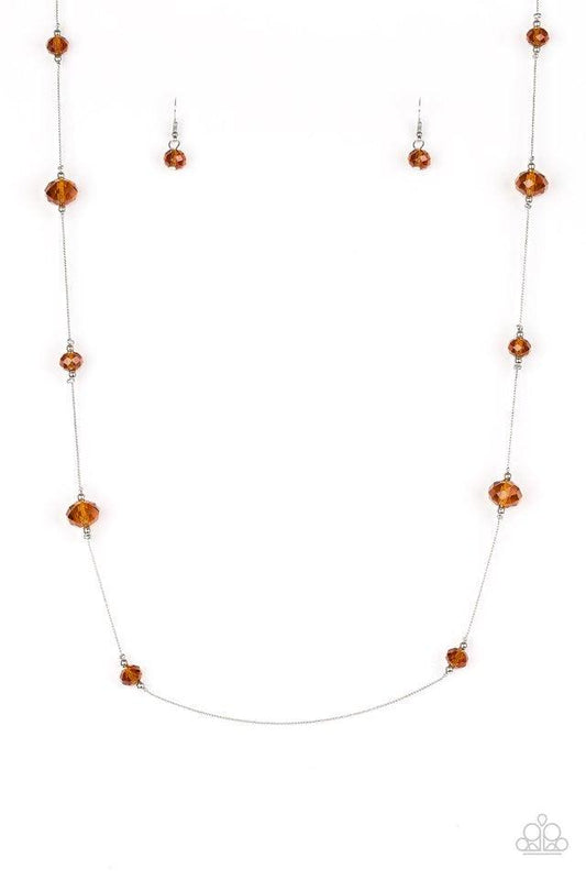 Paparazzi Accessories Champagne On The Rocks - Brown Infused with dainty silver accents, glittery brown crystal-like beads trickle along a dainty silver chain across the chest for a refined look. Features an adjustable clasp closure. Sold as one individua