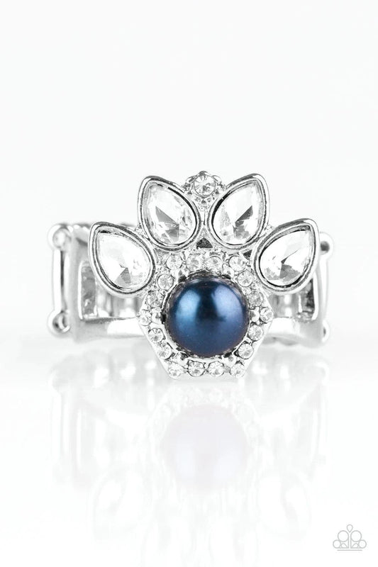 Paparazzi Accessories Crown Coronation - Blue Featuring regal teardrop cuts, glittery white rhinestones flare from the center of a blue pearl drop center. Dainty white rhinestones spin around the pearly center for a glamorous finish. Features a stretchy b