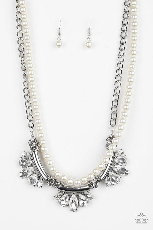 Paparazzi Accessories Bow Before The Queen - White A classic strand of white pearls and dramatic silvery chain drape below the collar. Infused with heavy metal accents, teardrop and marquise cut white rhinestone frames connect into a show-stopping fringe.