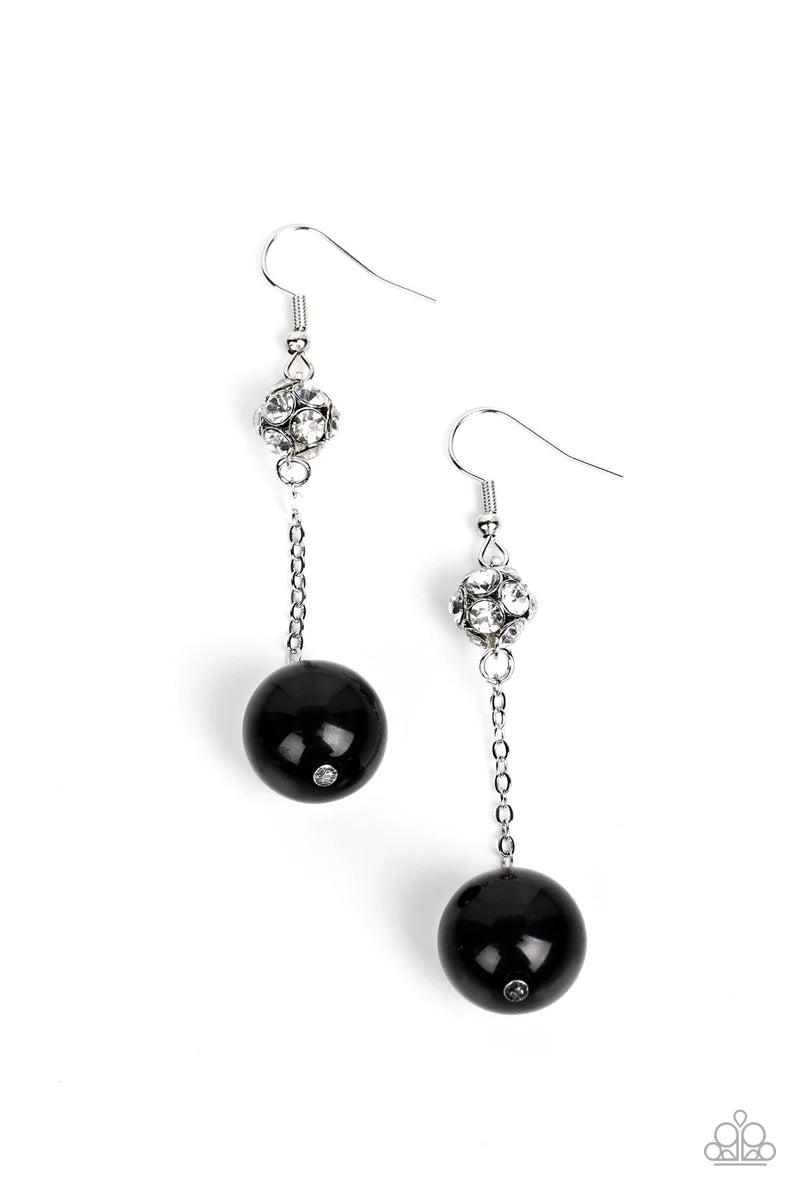 Paparazzi Accessories Nautical Nostalgia - Black An oversized black bead swings from the bottom of a dainty silver chain that is suspended from a white rhinestone encrusted silver bead, resulting in a timeless twist. Earring attaches to a standard fishhoo