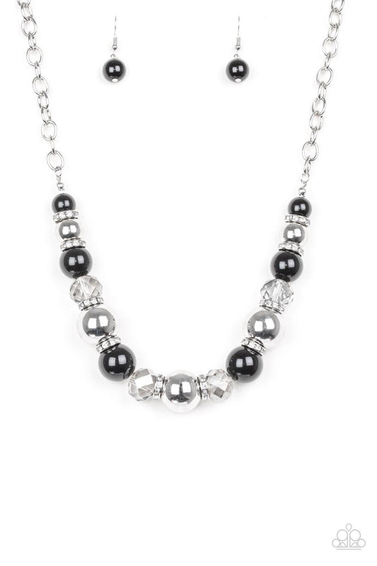 Paparazzi Accessories The Camera Never Lies - Black Oversized silver, smoky crystal-like, and polished black beads are threaded along an invisible wire below the collar for a glamorous look. White rhinestone encrusted rings are sprinkled between the drama