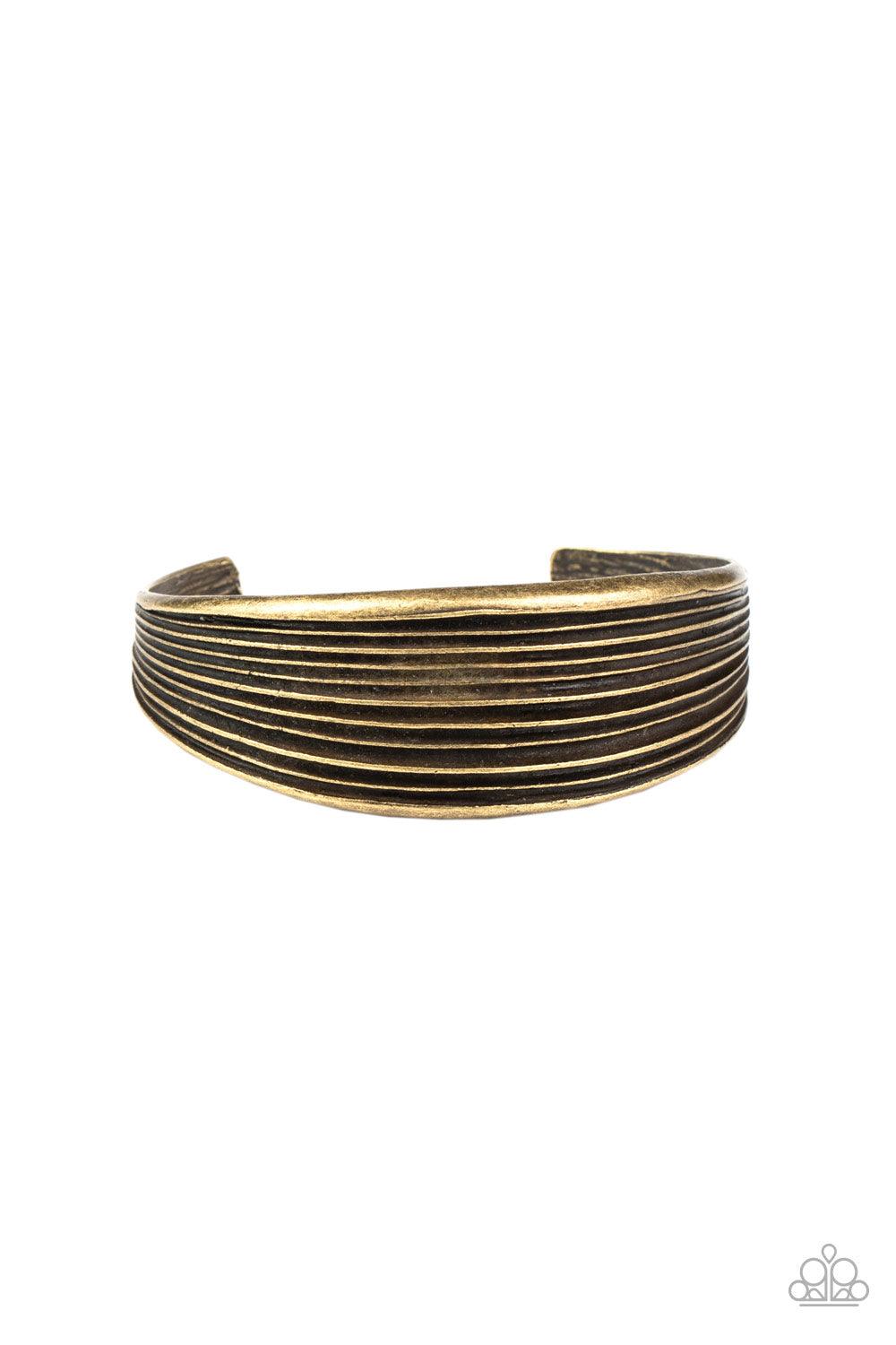 Paparazzi Accessories Off The Cuff Couture - Brass Featuring beveled linear texture, a thick brass cuff delicately curls around the wrist for a dash of rustic refinement. Sold as one individual bracelet. Jewelry