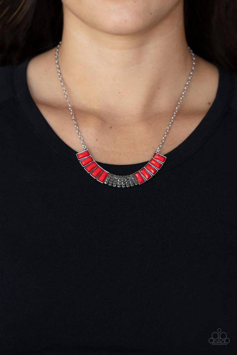 Paparazzi Accessories Coup de MANE - Red Stacked rows of hematite rhinestones and faceted emerald cut Fire Whirl beads coalesce into a colorful half moon pendant, creating a flamboyant pop of color below the collar. Features an adjustable clasp closure. S