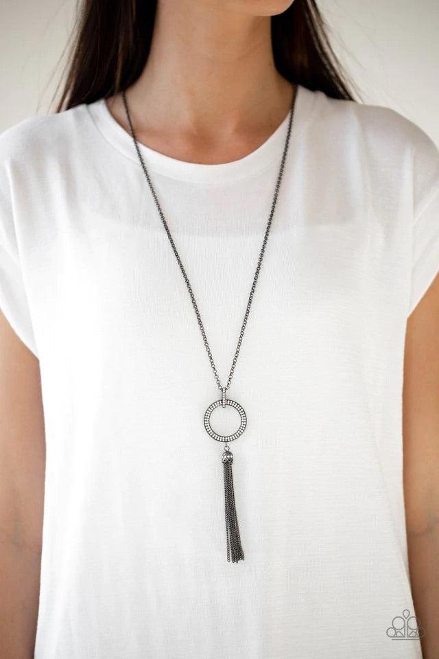 Paparazzi Accessories Straight To The Top - Black Encrusted in dazzling white rhinestones, a shimmery gunmetal hoop swings from the bottom of an elegantly elongated gunmetal chain for a refined look. A glistening gunmetal tassel swings from the bottom of