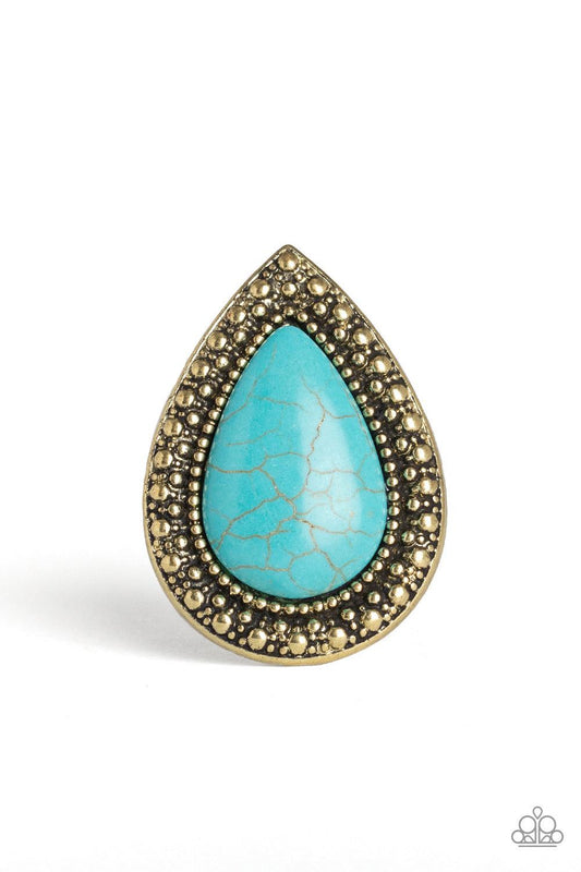 Paparazzi Accessories Santa Fe Storm - Brass Chiseled into a tranquil teardrop, an oversized turquoise stone is pressed into the center of a shimmery brass frame dotted with radiant studded texture for a dramatic stone look. Features a stretchy band for a