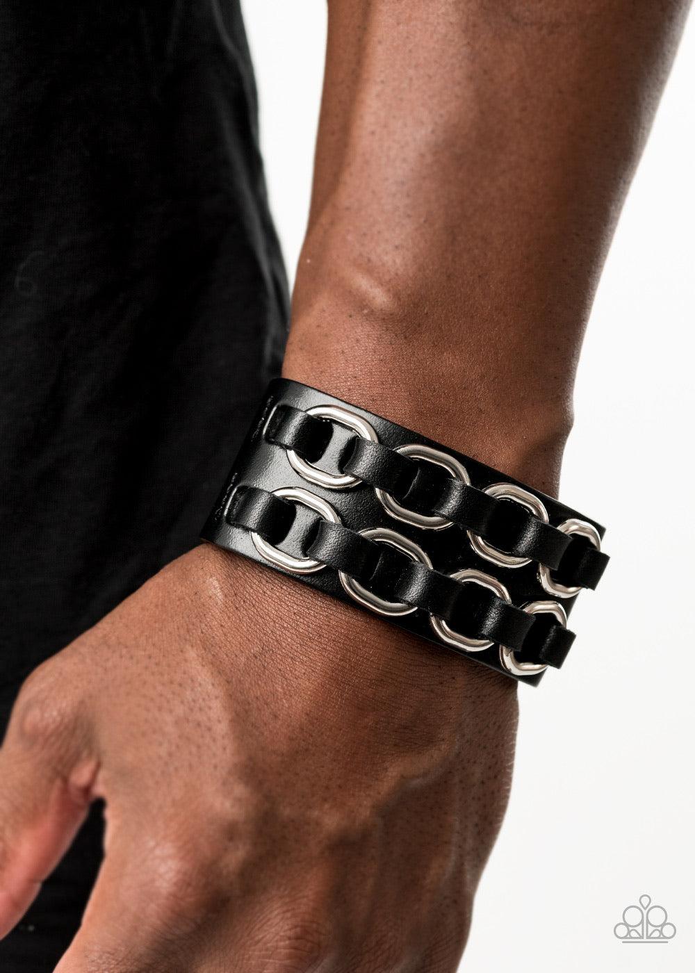 Paparazzi Accessories Throttle it Out - Black Black leather laces thread through two rows of bold silver links across the front of a thick black leather band for a gritty look. Features an adjustable snap closure. Jewelry