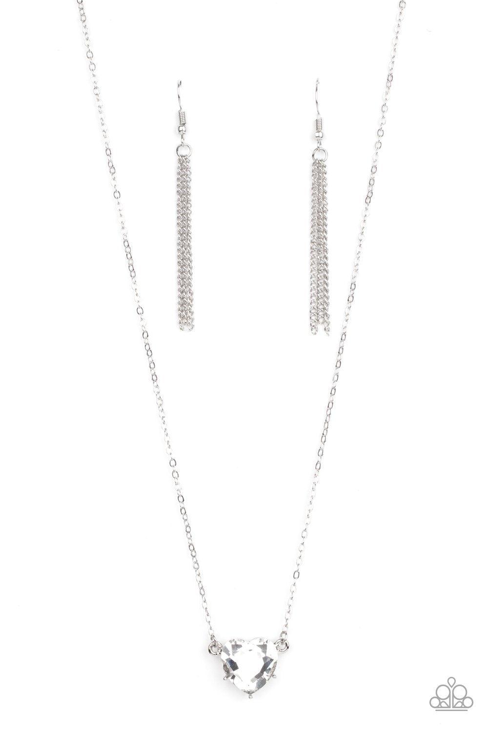 Paparazzi Accessories She Works HEART for the Money - White Cut into a flirtatious heart shape, a dramatically oversized white rhinestone pendant swings from the bottom of a dainty silver chain below the collar for a glamorous finish. Features an adjustab