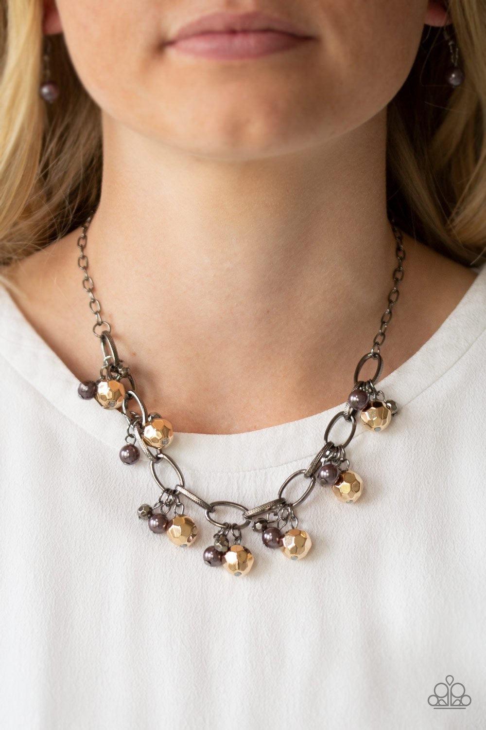 Paparazzi Accessories Malibu Movement - Multi Varying in size, a collection of faceted gold and pearly gunmetal beads swings from a bold gunmetal chain, creating a whimsical metallic fringe below the collar. Features an adjustable clasp closure. Sold as o