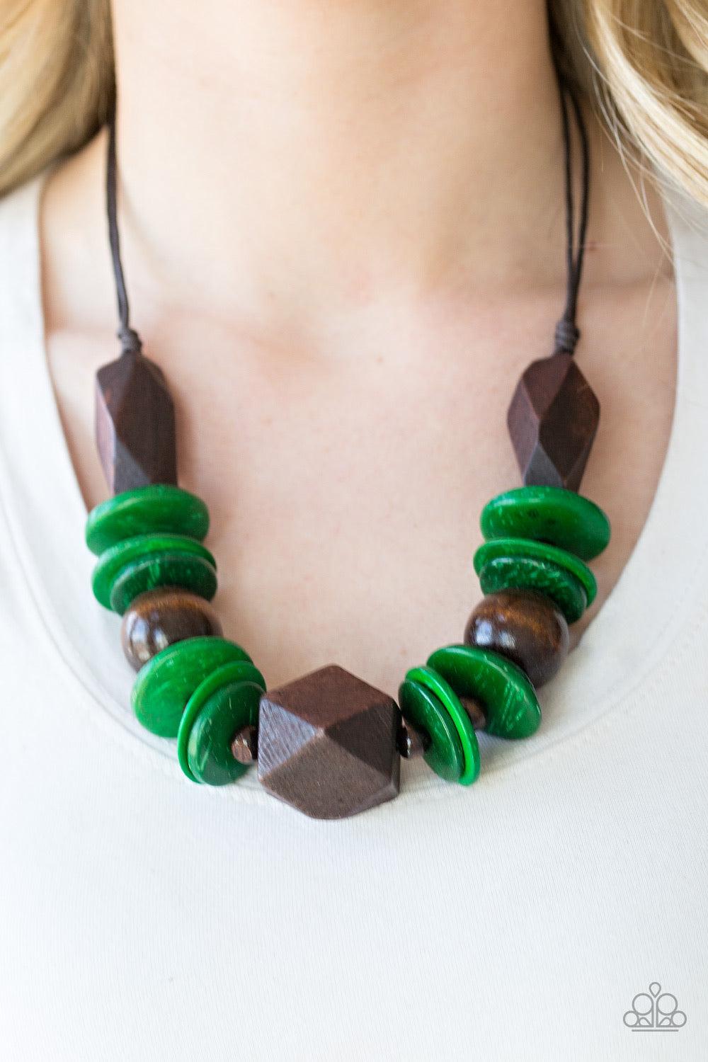 Paparazzi Accessories Pacific Paradise - Green Featuring abstract geometric finishes, mismatched brown wooden beads and refreshing green accents are threaded along shiny brown cording. A dramatic geometric bead adorns the center, creating a bold summery l