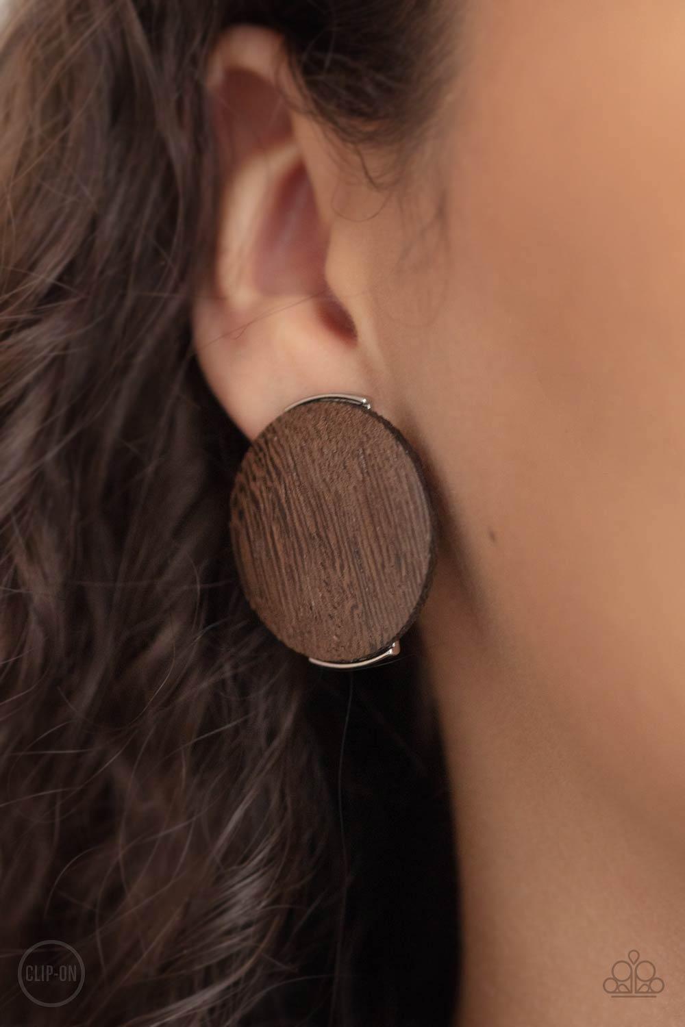 Paparazzi Accessories WOODWORK It ~Brown *Clip-On An oversized brown wooden disc is fitted in place between a silver frame, creating an earthy effect. Earring attaches to a standard clip-on fitting. Sold as one pair of clip-on earrings. Jewelry