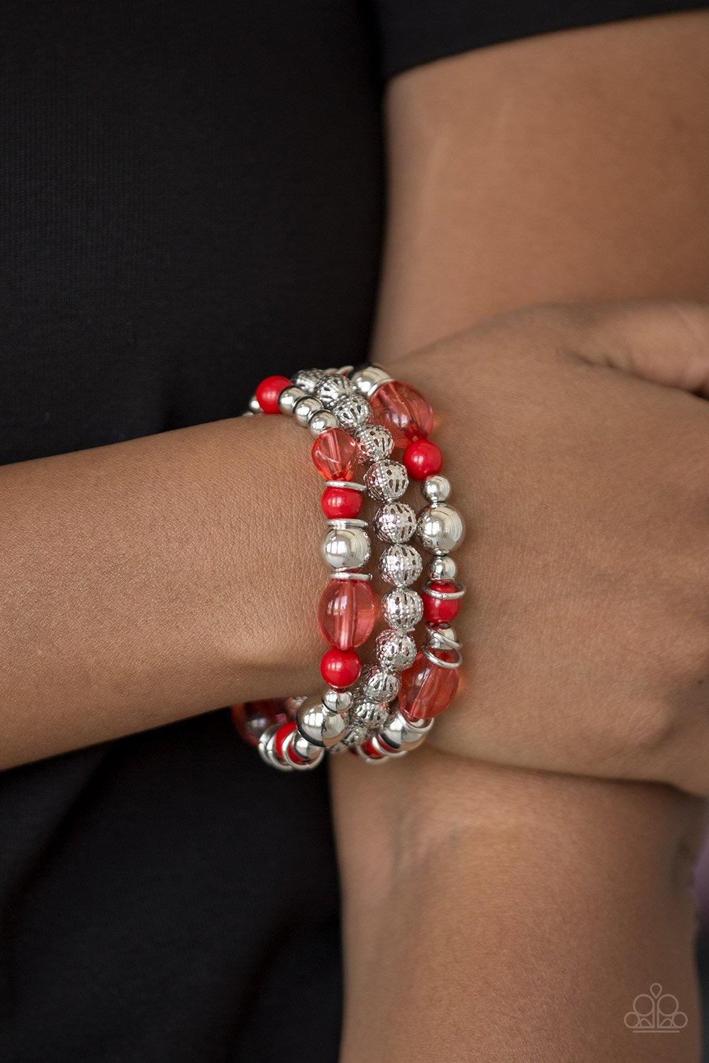 Paparazzi Accessories Malibu Marina - Red An array of glassy and polished red beading and mismatched silver accents are threaded along stretchy elastic bands, creating colorful layers across the wrist. Jewelry