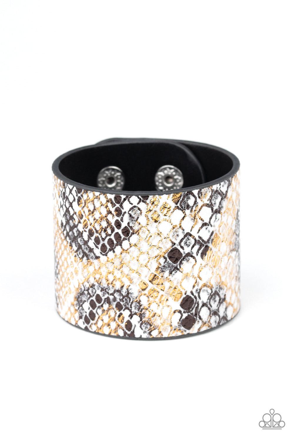 Paparazzi Accessories Serpent Shimmer - Multi Featuring a shiny gold and black python print, a thick white leather band wraps around the wrist for a wild shimmer. Features an adjustable snap closure. Sold as one individual bracelet. Jewelry