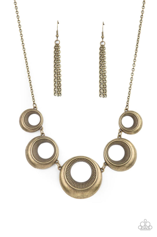 Paparazzi Accessories Solar Cycle - Brass Featuring studded centers, an antiqued collection of beveled brass hoops gradually increase in size as they link below the collar for a bold metallic look. Features an adjustable clasp closure. Sold as one individ