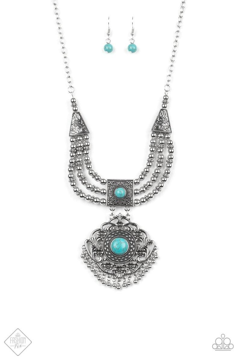 Paparazzi Accessories Santa Fe Solstice - Blue A vintage inspired pendant adorned in intricate studded textures and bordered by a shiny fringe of silver beads attaches to a squared frame rich in detail. Turquoise stones dot each anchoring piece, bringing