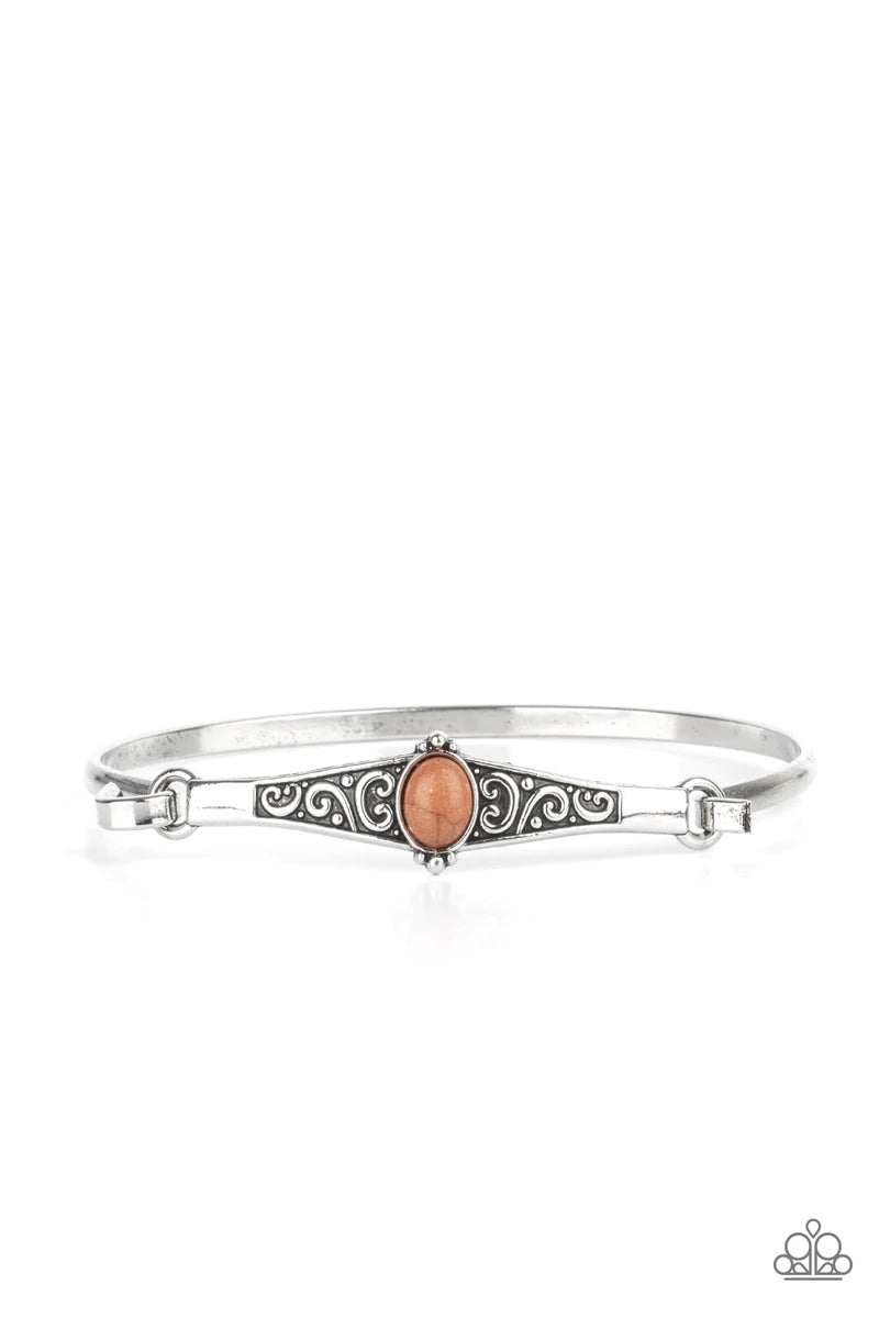 Paparazzi Accessories Stone Scrolls - Brown Dotted with an oval brown stone, an antiqued silver frame is embossed with a vine-like scroll that hooks to a dainty cuff-like bangle, creating a whimsical centerpiece. Sold as one individual bracelet. Bracelets