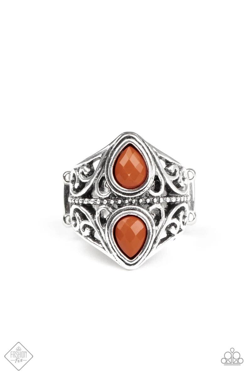 Paparazzi Accessories Rural Revel - Brown Two back-to-back Cinnamon Stick teardrop beads sit atop a stacked band of silver filigree, creating a whimsical centerpiece atop the finger. Features a stretchy band for a flexible fit. Sold as one individual ring