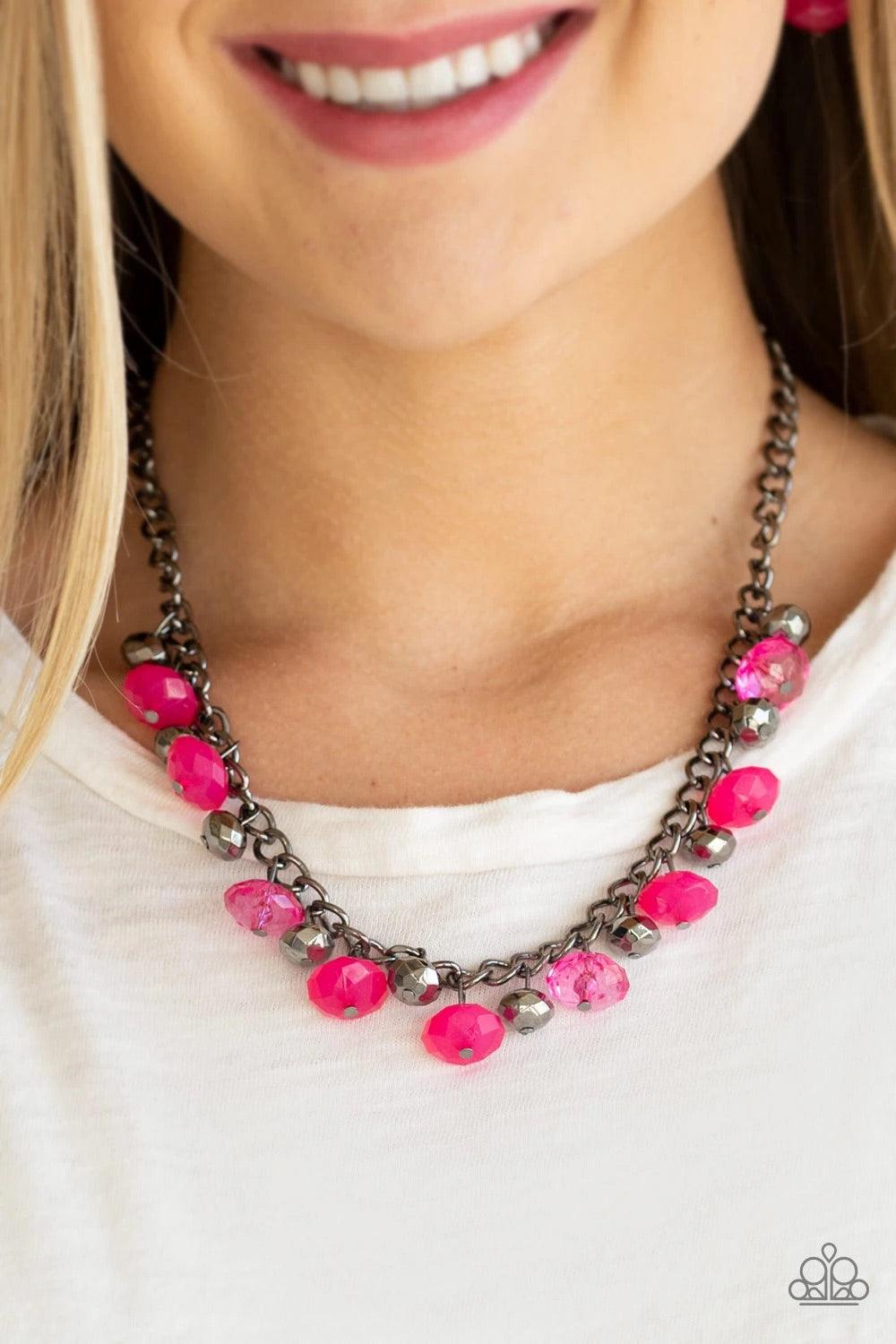 Paparazzi Accessories Runway Rebel - Pink Featuring cloudy and glassy finishes, faceted pink crystal-like beads swing from the bottom of a glistening gunmetal chain. Faceted gunmetal beads join the pink beading, creating a flirtatious fringe below the col