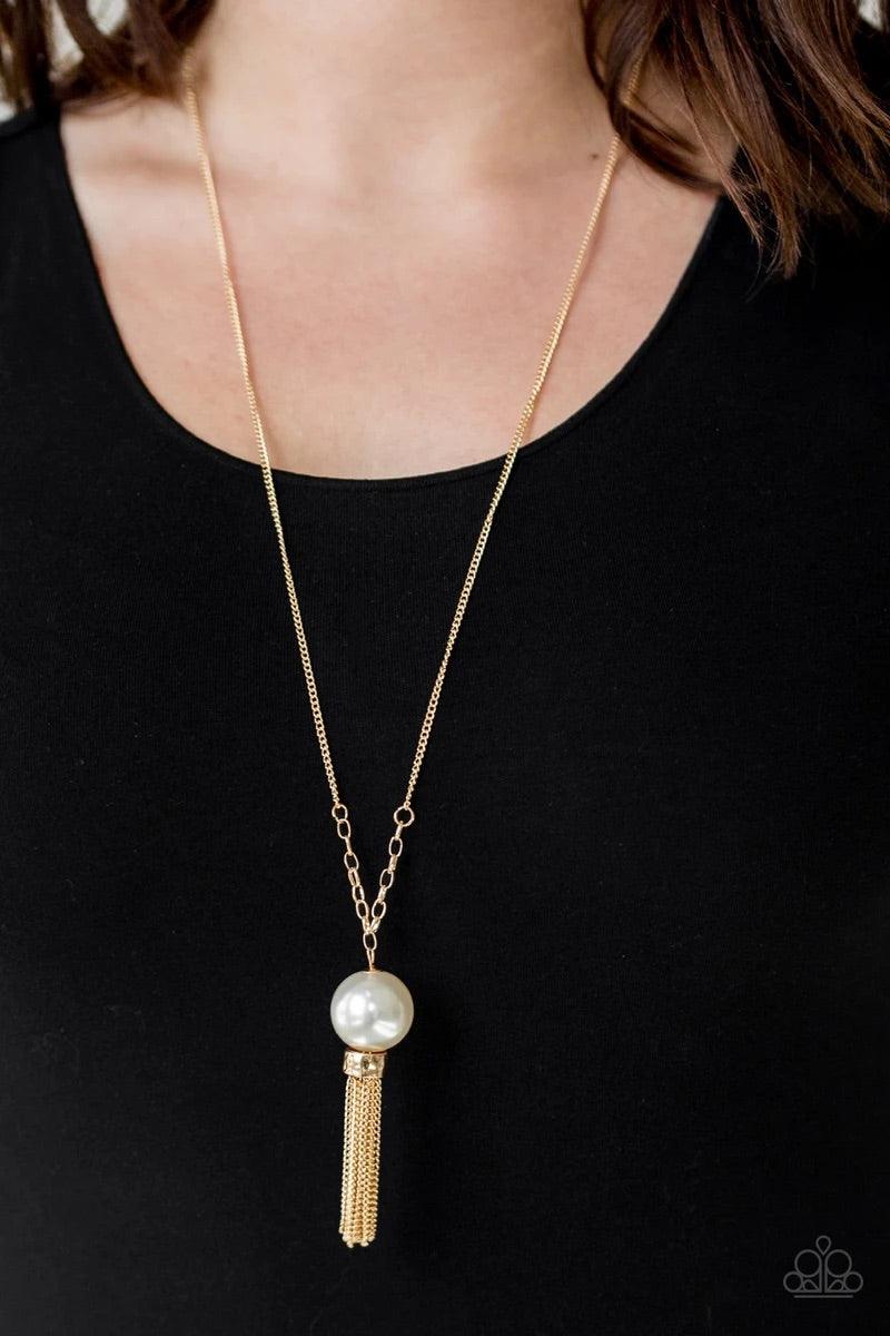 Paparazzi Accessories Belle of the Ballroom - Gold A dramatic pearly white bead swings from the bottom of an elegantly elongated gold chain. Featuring a hammered fitting, a gold tassel streams from the bottom of the colorful pendant for a refined finish.