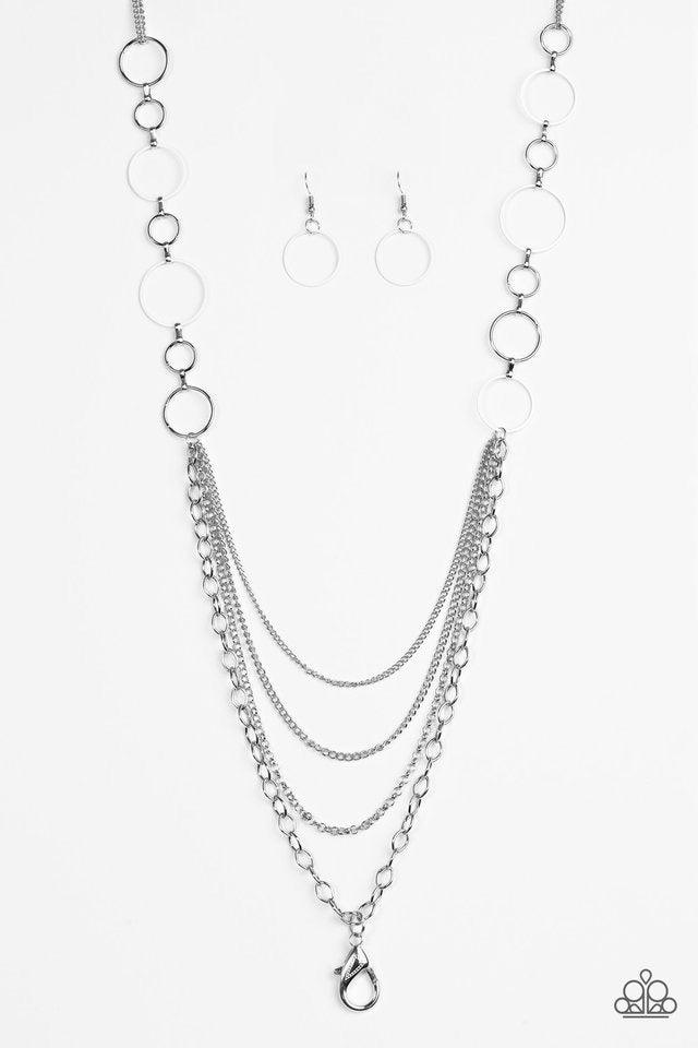 Paparazzi Accessories Industrial Circus - White *Lanyard Neutral white and shiny silver hoops give way to layers of mismatched silver chain for an edgy look. A lobster clasp hangs from the bottom of the design to allow a name badge or other item to be att