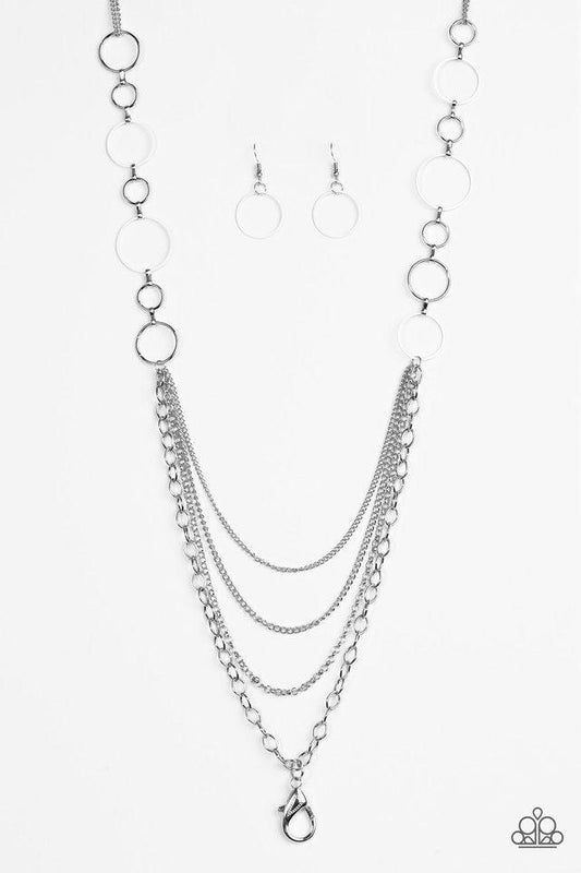 Paparazzi Accessories Industrial Circus - White *Lanyard Neutral white and shiny silver hoops give way to layers of mismatched silver chain for an edgy look. A lobster clasp hangs from the bottom of the design to allow a name badge or other item to be att