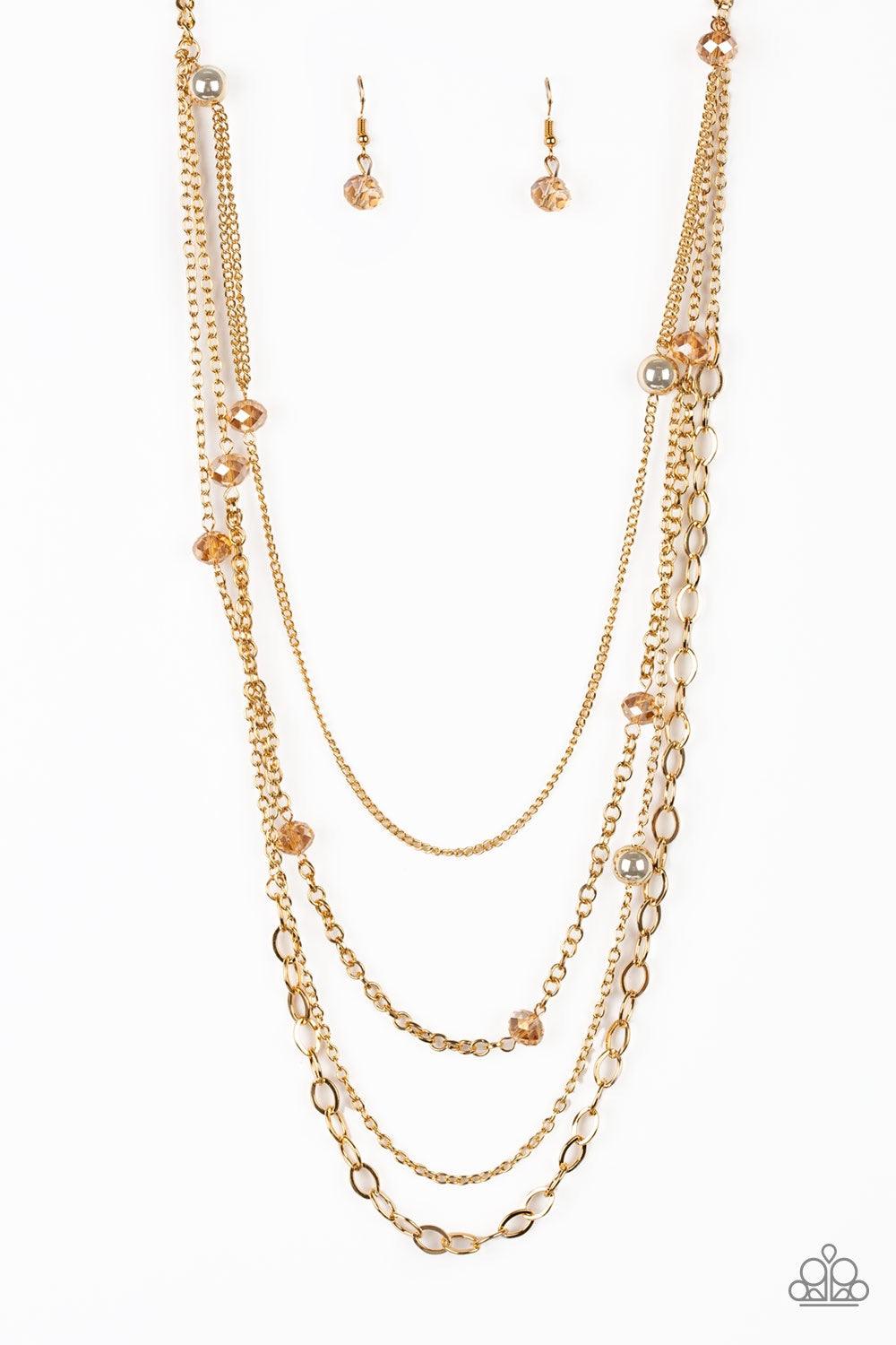 Paparazzi Accessories Glamour Grotto - Gold Golden crystal-like beads and shimmery gold beads trickle along mismatched gold chains, creating refined layers down the chest. Features an adjustable clasp closure. Jewelry