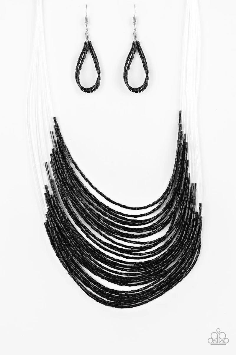 Paparazzi Accessories Catwalk Queen - Black Strand after strand of shimmering black seed beads fall together to create a bold statement piece. Features an adjustable clasp closure. Sold as one individual necklace. Includes one pair of matching earrings. J